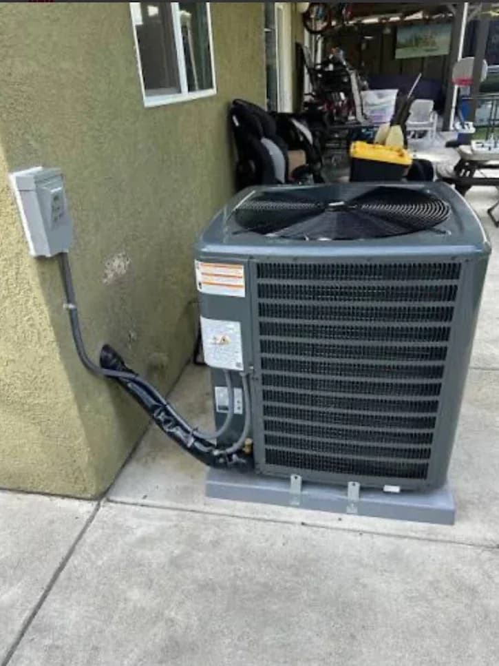 The electrical disconnect and wiring beside an outdoor air conditioning condenser